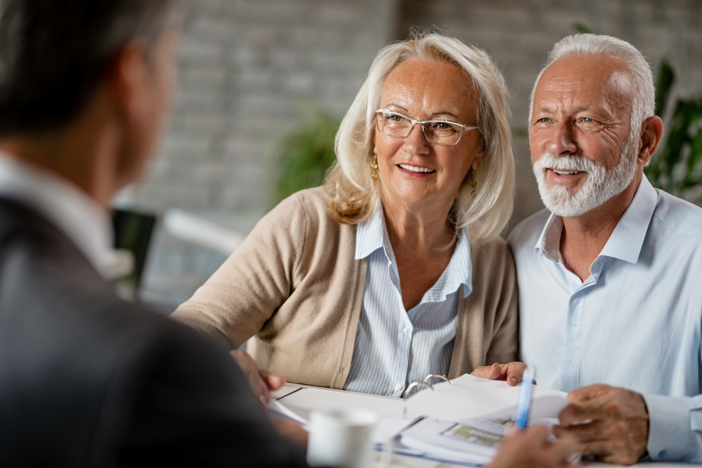 Couple approaching retirement meet with their financial planner to review their pension annuities.